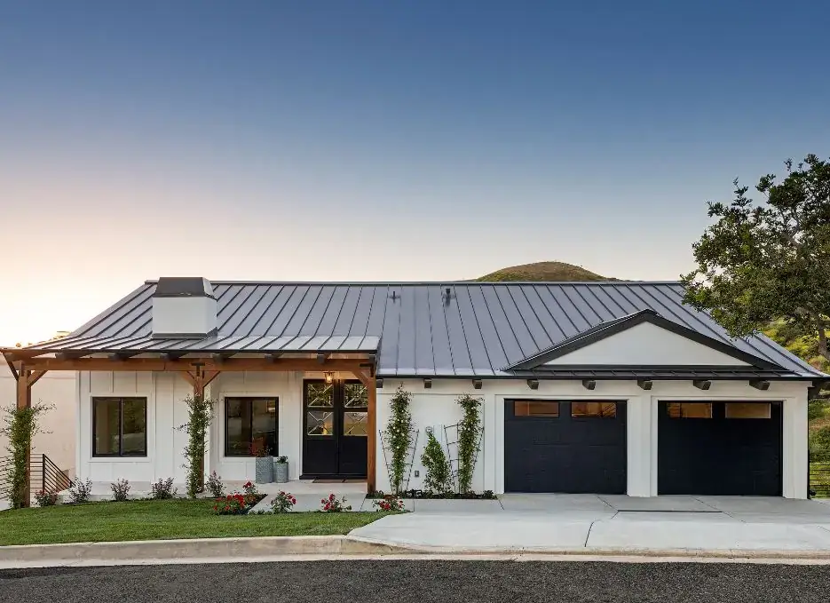 New black garage doors on a modern farmhouse