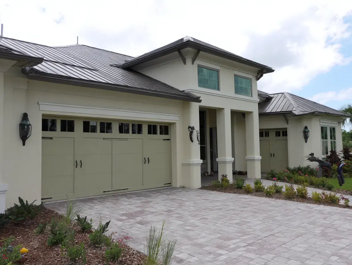 Florida home with a sage carriage-style garage door in Englewood